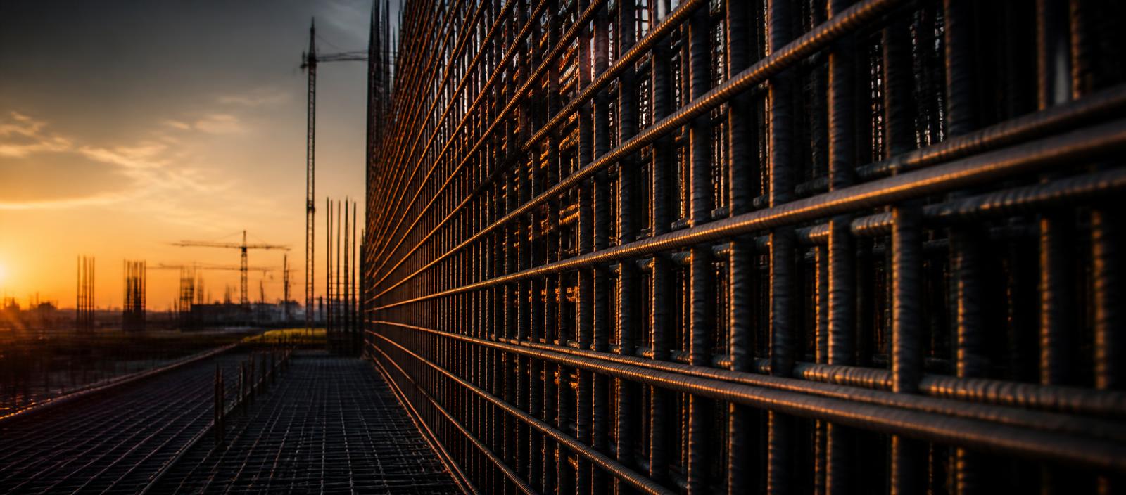 Reinforcing steel cage at a construction site at sunset